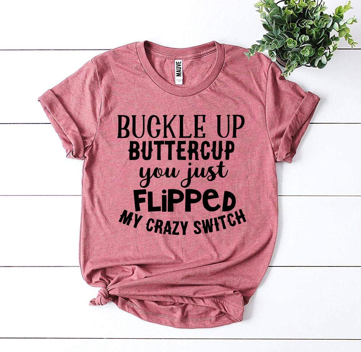 Pink t-shirt with black text: "Buckle Up Buttercup You Just Flipped My Crazy Switch," on a white background.