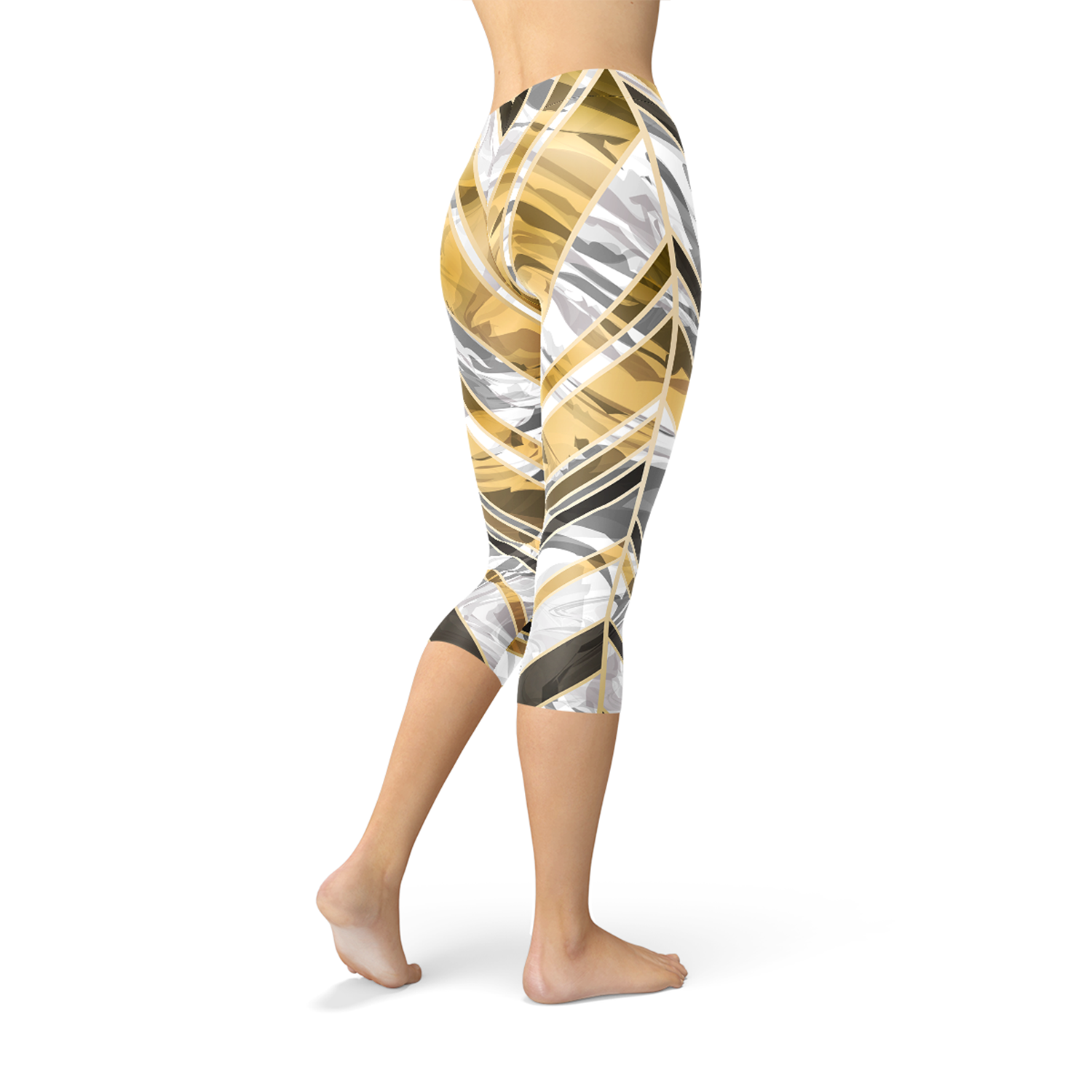 A woman wears leggings with gold and gray geometric patterns, walking barefoot on a white background.