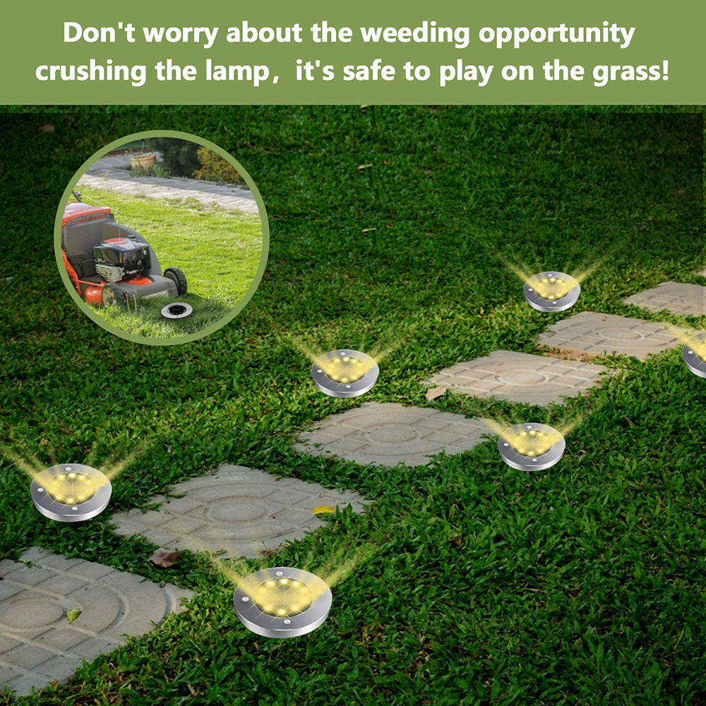 Solar lights on grassy lawn beside stone path, text above about safety with lawnmowers.