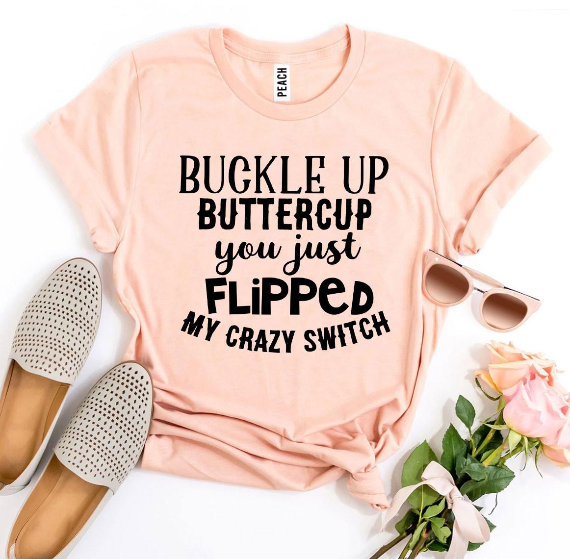Peach T-shirt with bold black text, sunglasses, beige shoes, and pink roses with green leaves.