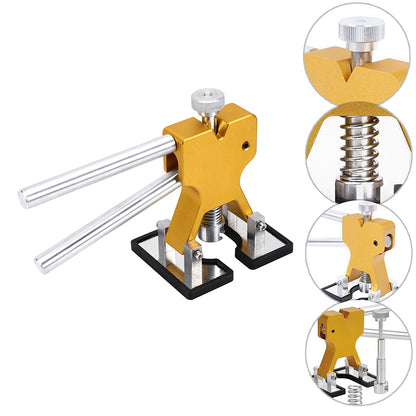 Gold paintless dent repair tool with silver handles and base; features detailed in circular insets.