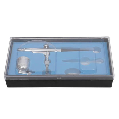 Silver airbrush kit in a black box with a clear lid and blue interior, featuring accessory slots.