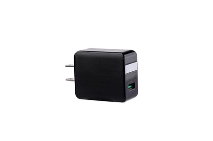 Black square plug with dual prongs, USB port, silver accent, and green interior on white background.