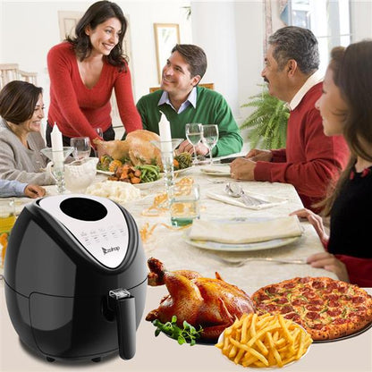 Family dining with a black air fryer, whole chicken, fries, and pizza on the table.