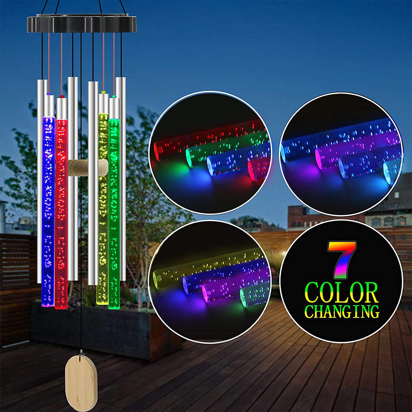 Colorful LED wind chimes with seven color-changing tubes, set against a patio background.