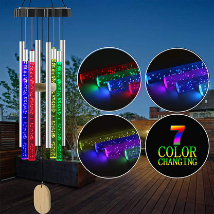 Colorful LED wind chimes with seven color-changing tubes, set against a patio background.