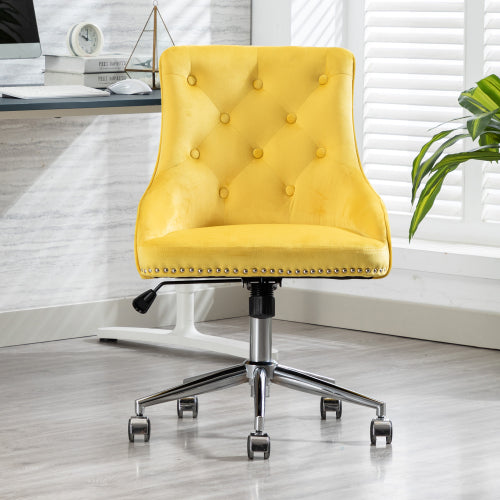 Yellow tufted office chair with chrome base on wheels, near desk in bright room with shutters.