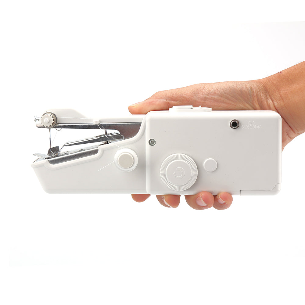 Hand holding a white handheld sewing machine against a white background.