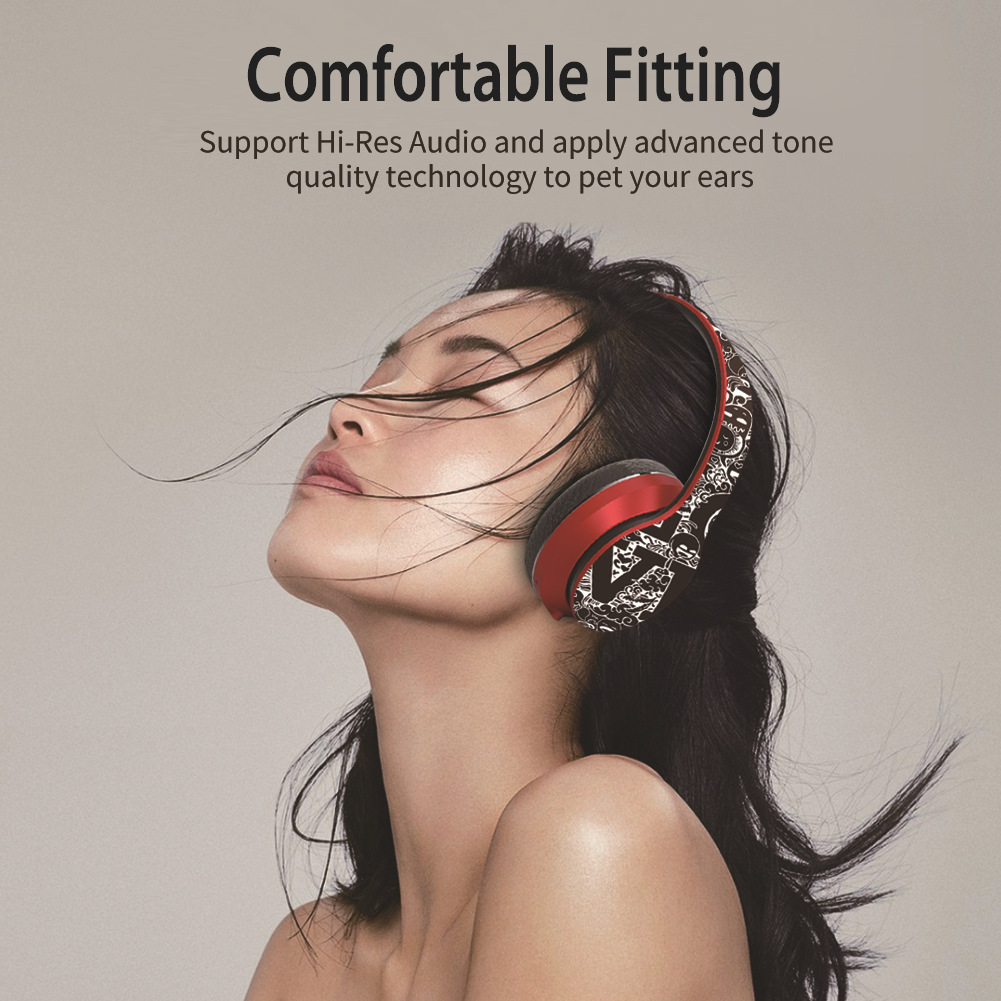 Woman with closed eyes wearing red headphones, hair blowing, text reads "Comfortable Fitting."