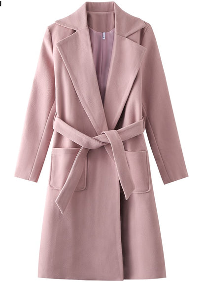 Pink coat with wide lapels and a belt, featuring front pockets on either side.