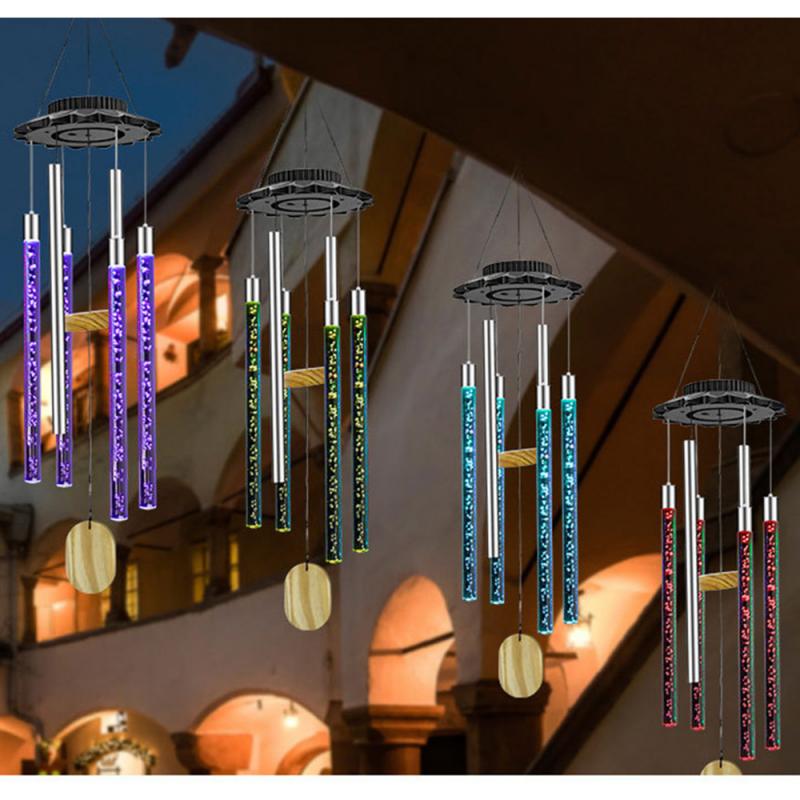 Colorful LED wind chimes with glowing tubes in purple, green, blue, and red hang in an archway.