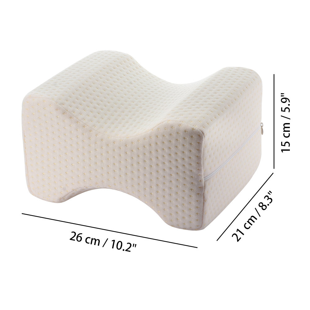 Cream orthopedic knee pillow with dimpled texture; dimensions 26x21x15 cm.