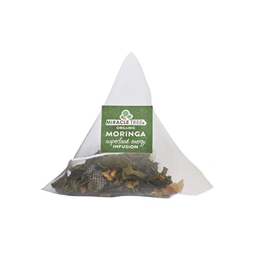 Triangular mesh tea bag with herbs, featuring a green label that reads "Organic Moringa."