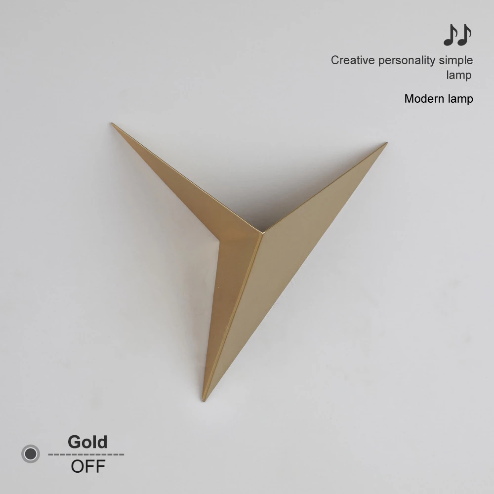 Gold triangular modern lamp on white background with text "Creative personality simple lamp."