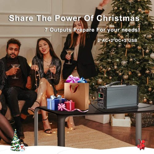 A group of people celebrate near a Christmas tree with gifts and a power station on a table.