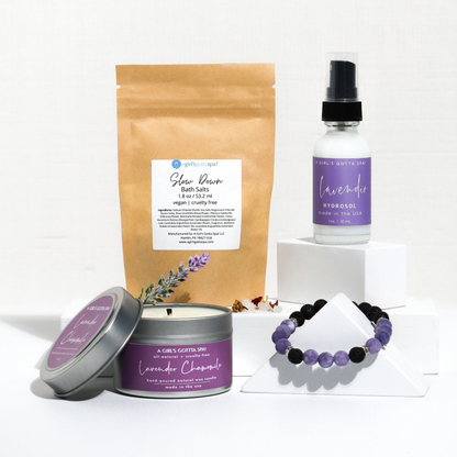 Lavender-themed spa products include a candle, bath salts, hydrosol, and a purple-black bracelet.