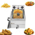 A stainless steel fryer with a basket of fries, surrounded by fried chicken and nuggets.