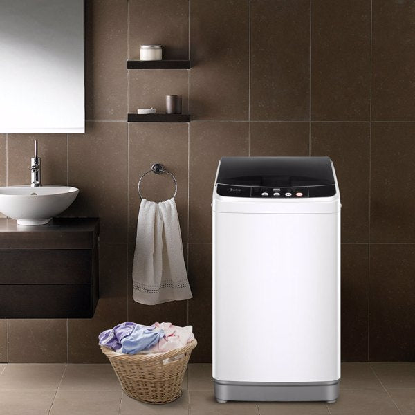 Washing machine in a modern bathroom with brown tiles, a laundry basket, and a wall-mounted sink.