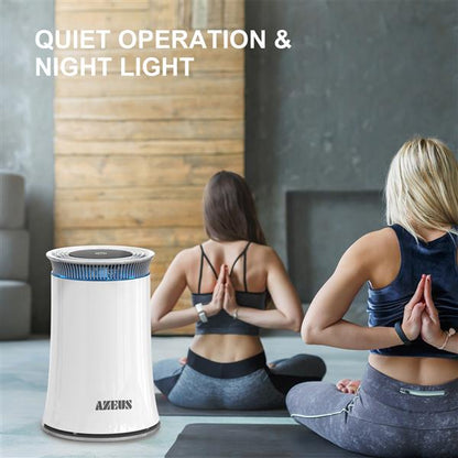 White air purifier with blue accents near two people doing yoga in a room with wood and gray walls.