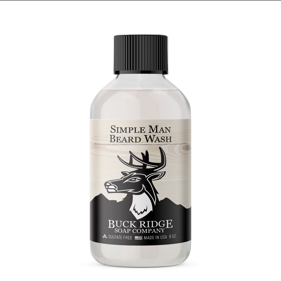 Clear bottle of beard wash with a black label, deer logo, black cap, and rustic wood design.