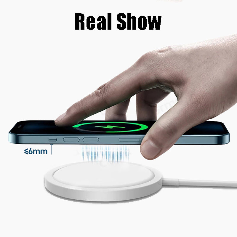 Hand holding a smartphone above a white charging pad, displaying wireless charging signal.