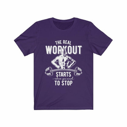 Purple T-shirt with white graphic of a muscular figure and barbell, text reads: "The real workout starts when you want to stop."
