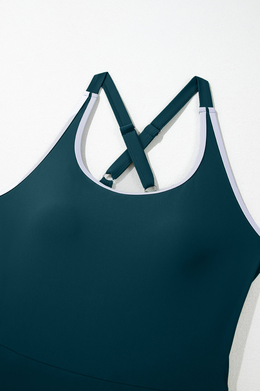 Teal tank top with white trim and cross-back straps on a white background.