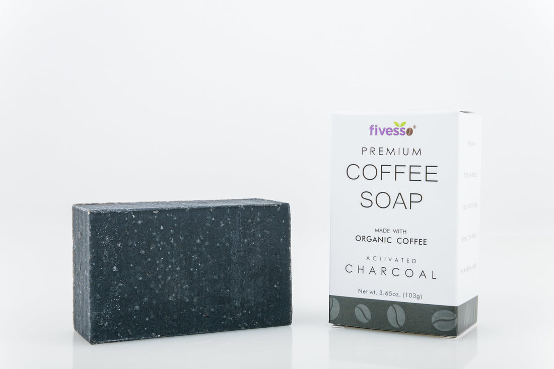 Dark gray rectangular soap bar beside white box labeled "Premium Coffee Soap."