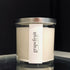 Clear glass candle with white wax, silver lid, and a label reading "grapefruit."