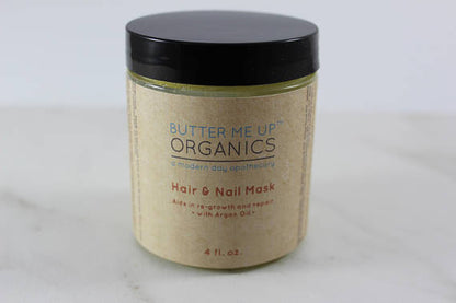 Jar of hair and nail mask with black lid, beige label, blue and red text, on a light surface.
