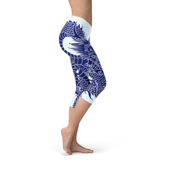 Side view of a woman wearing blue dragon-patterned leggings, standing on tiptoe.
