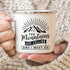 White mug with "The Mountains Are Calling and I Must Go" text, held by hands in a knitted sweater.