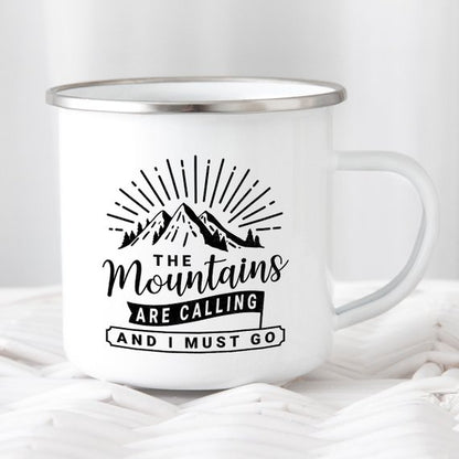 White metal mug with mountain design and text: "The mountains are calling and I must go."