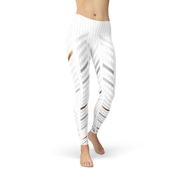 Person wearing white leggings with striped cutouts and small dotted pattern, standing barefoot.