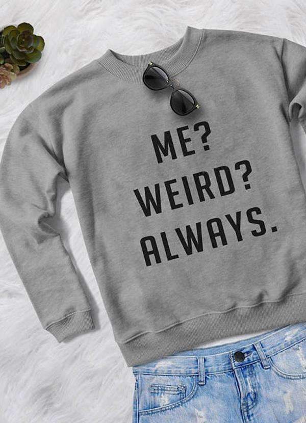 Gray sweatshirt with "Me? Weird? Always." text, black sunglasses, and denim shorts on white background.