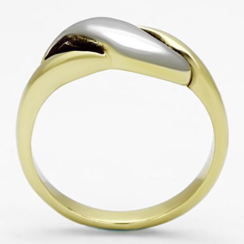 Gold ring with a sleek, curved silver accent on top against a white background.