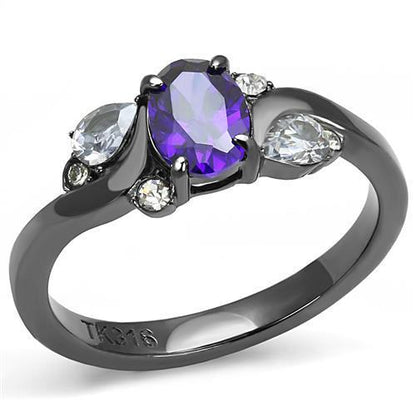Black ring with an oval purple stone, flanked by pear-shaped clear stones, set in silver.