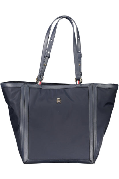 Dark blue tote bag with adjustable straps, stitched edges, and a small gold logo on the front.