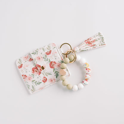 Floral cardholder with a matching tassel and multicolor beaded keychain on a white background.